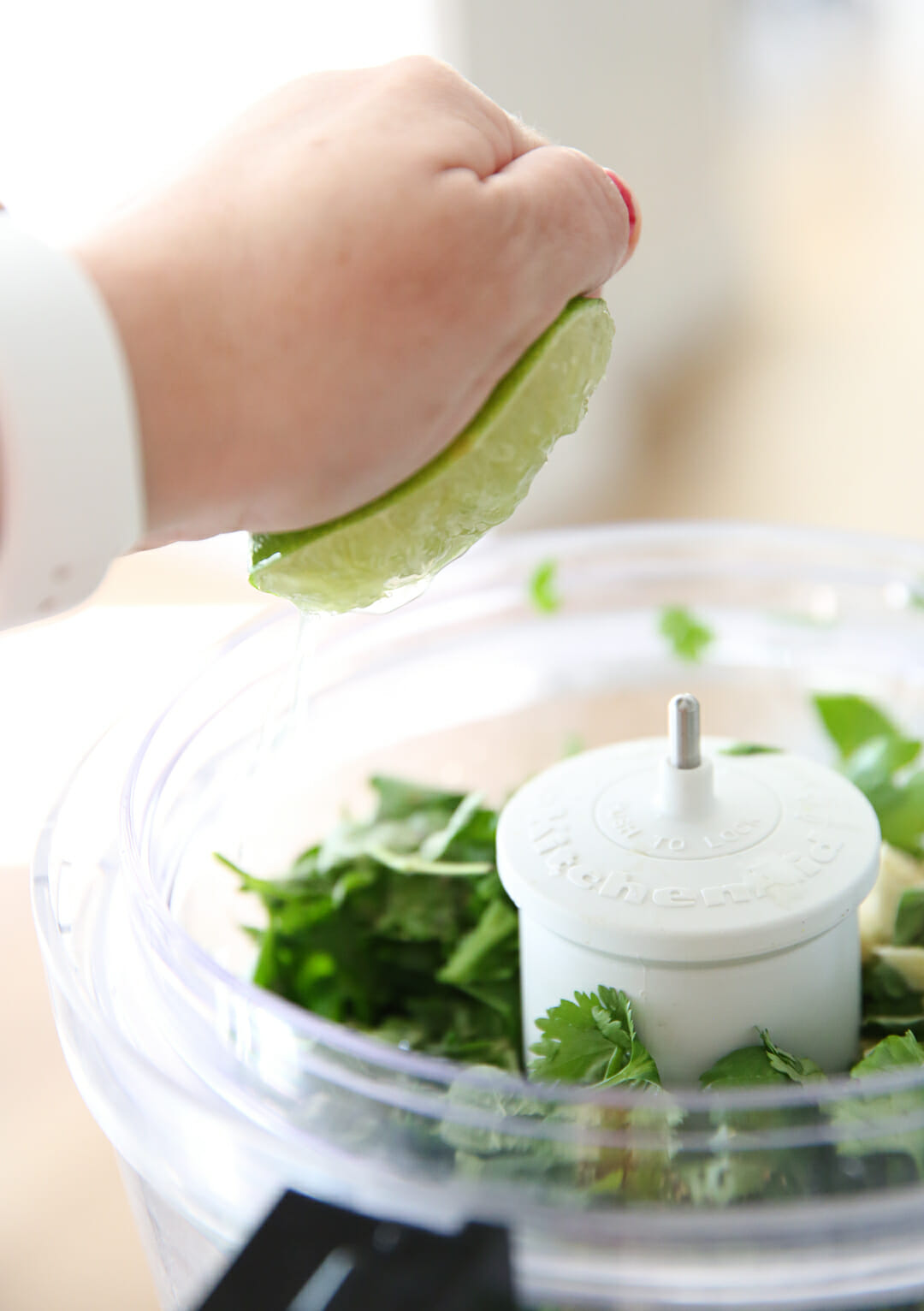 Squeezing lime juice in chimichurri