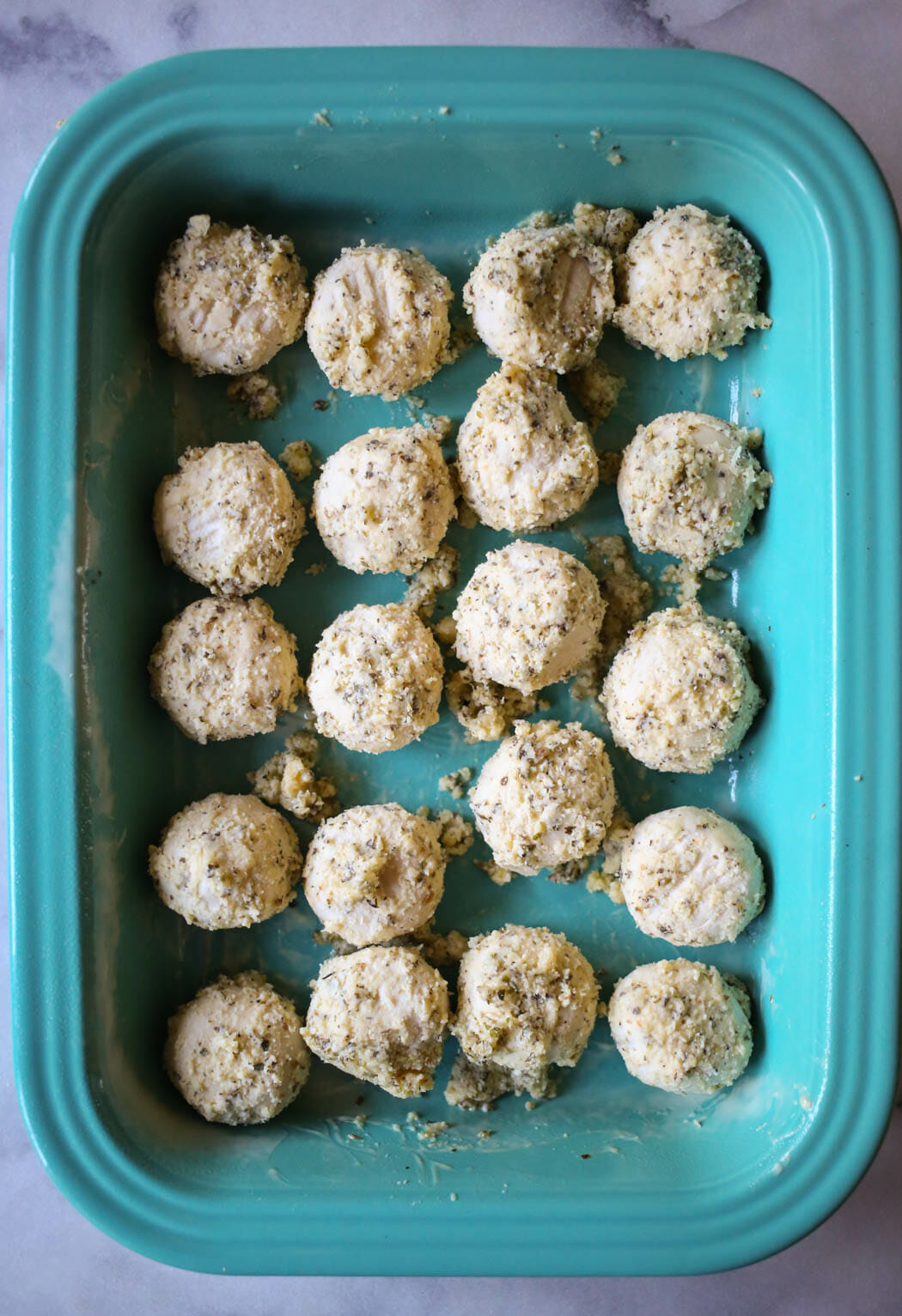 seasoned dough balls in a pan