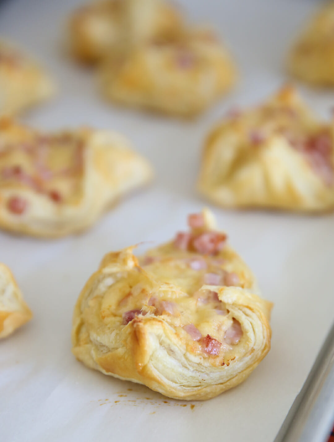 cooked ham and cheese pastries on pan