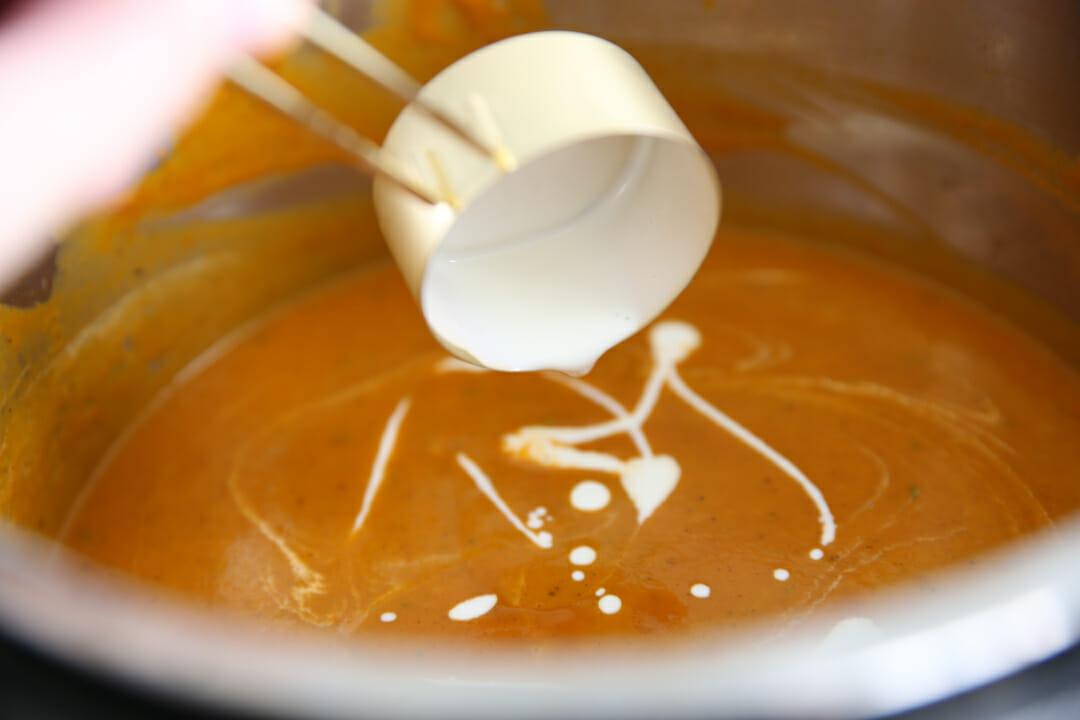 Adding cream to tomato soup