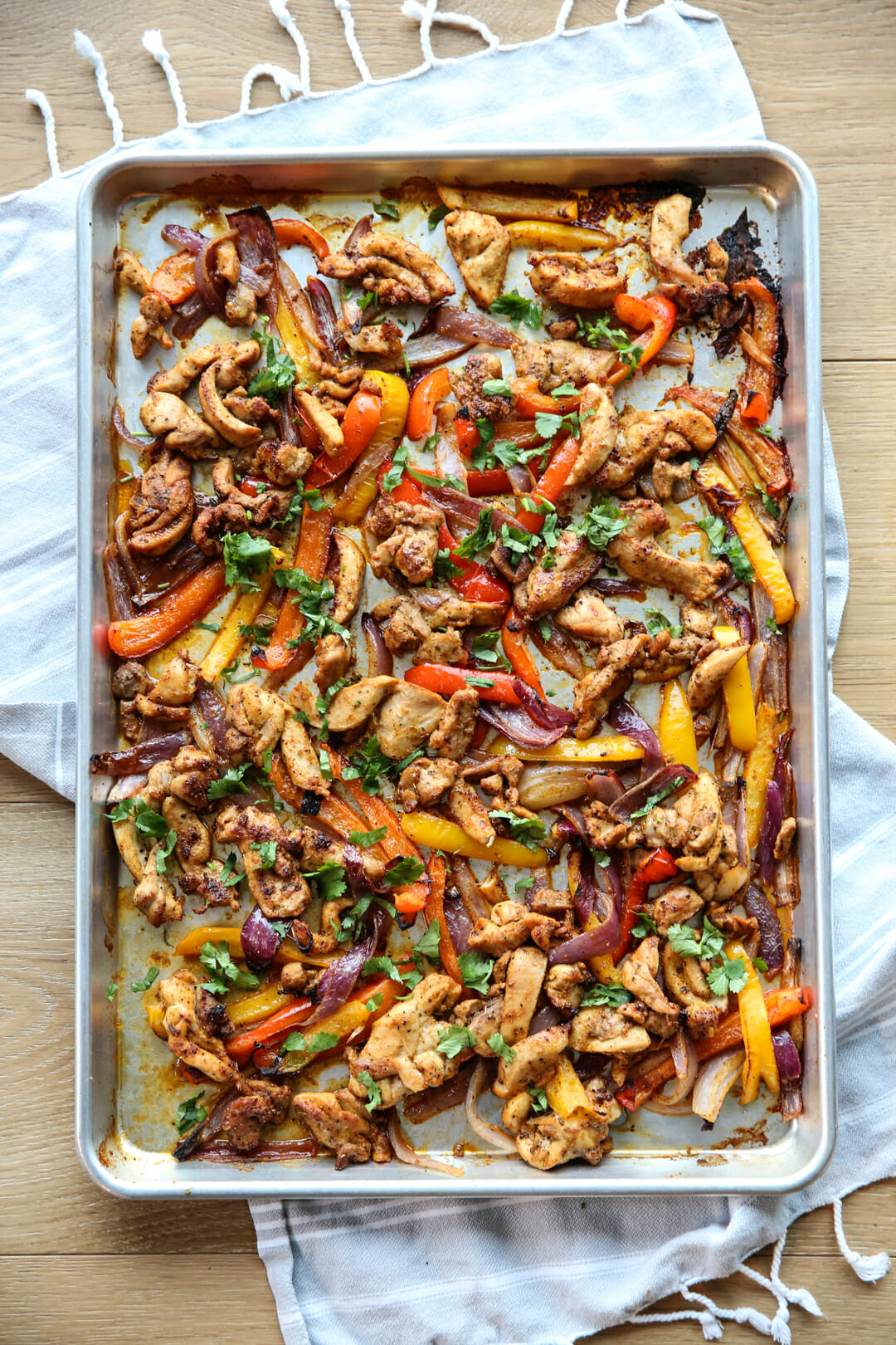 chicken peppers and onion on a sheet pan