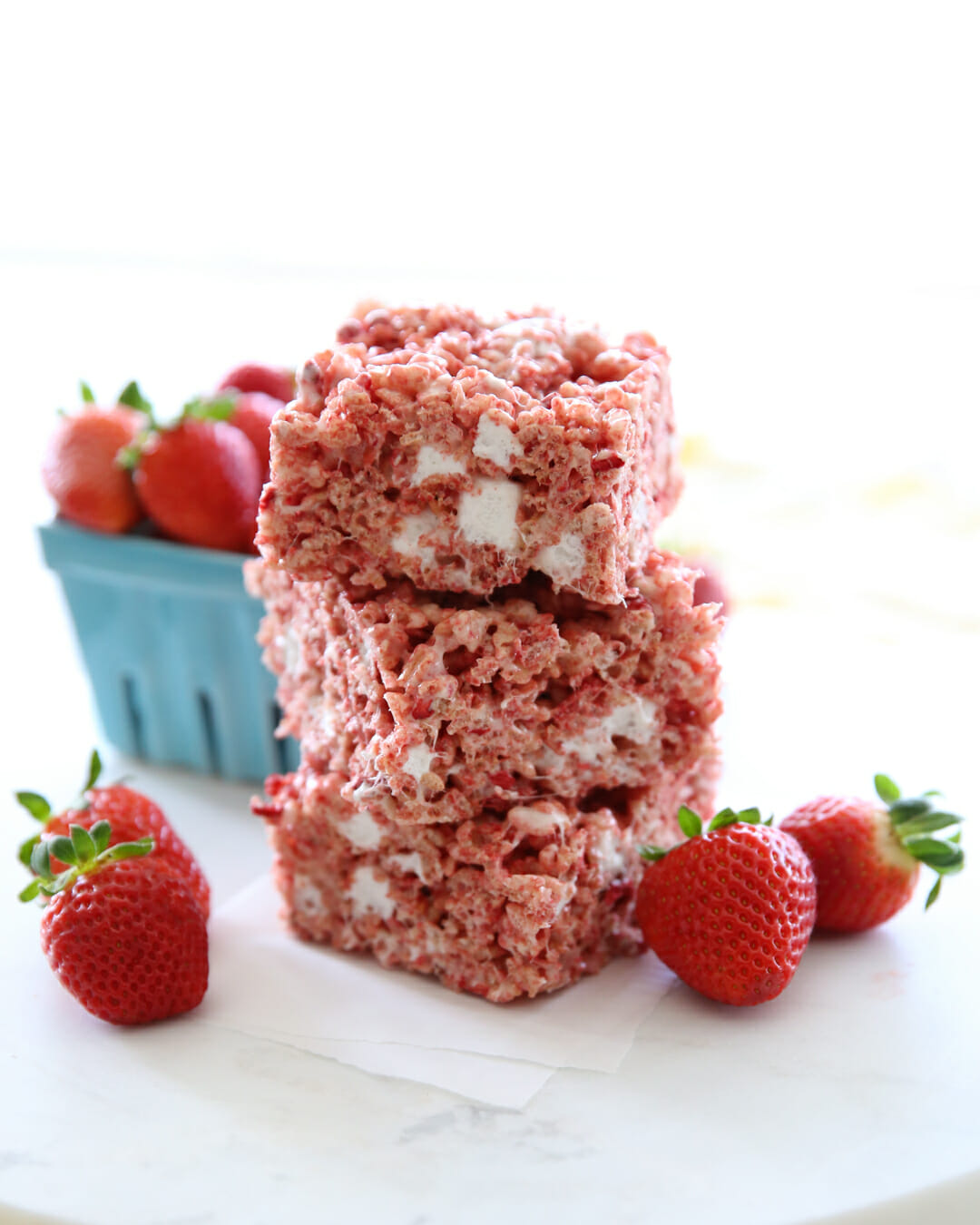 rice krispie treats on plate with berries