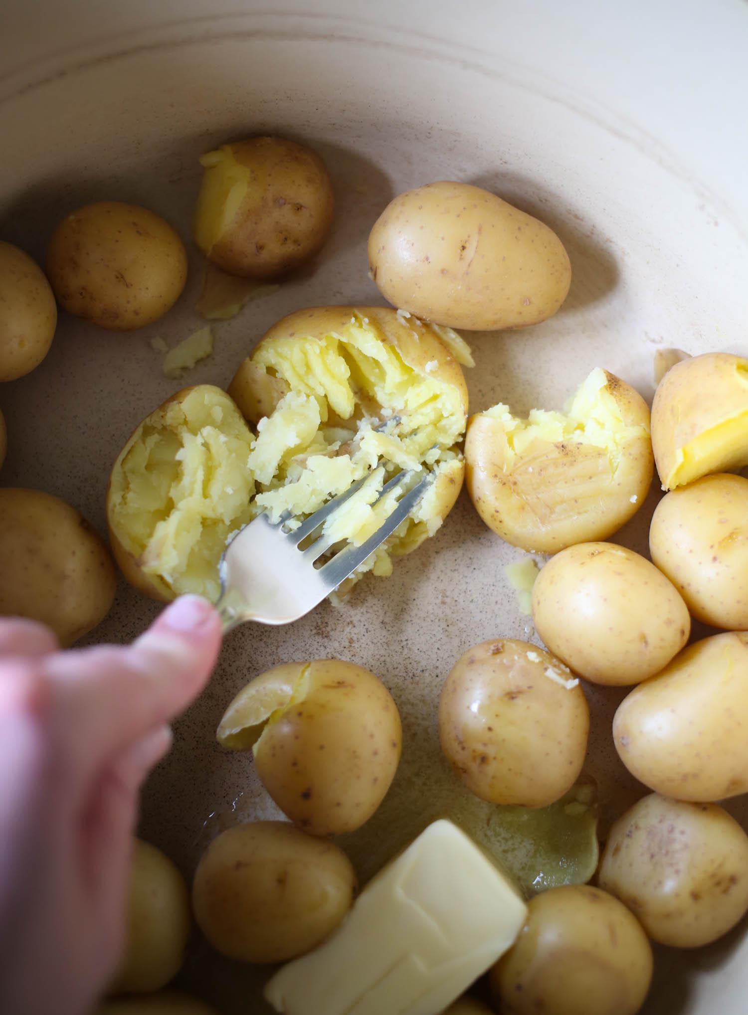 mashing potatoes with fork
