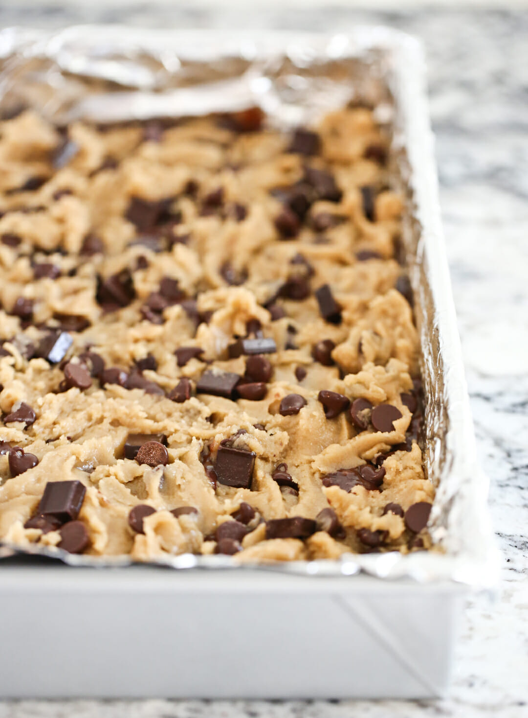 chocolate chip cookie dough in a pan