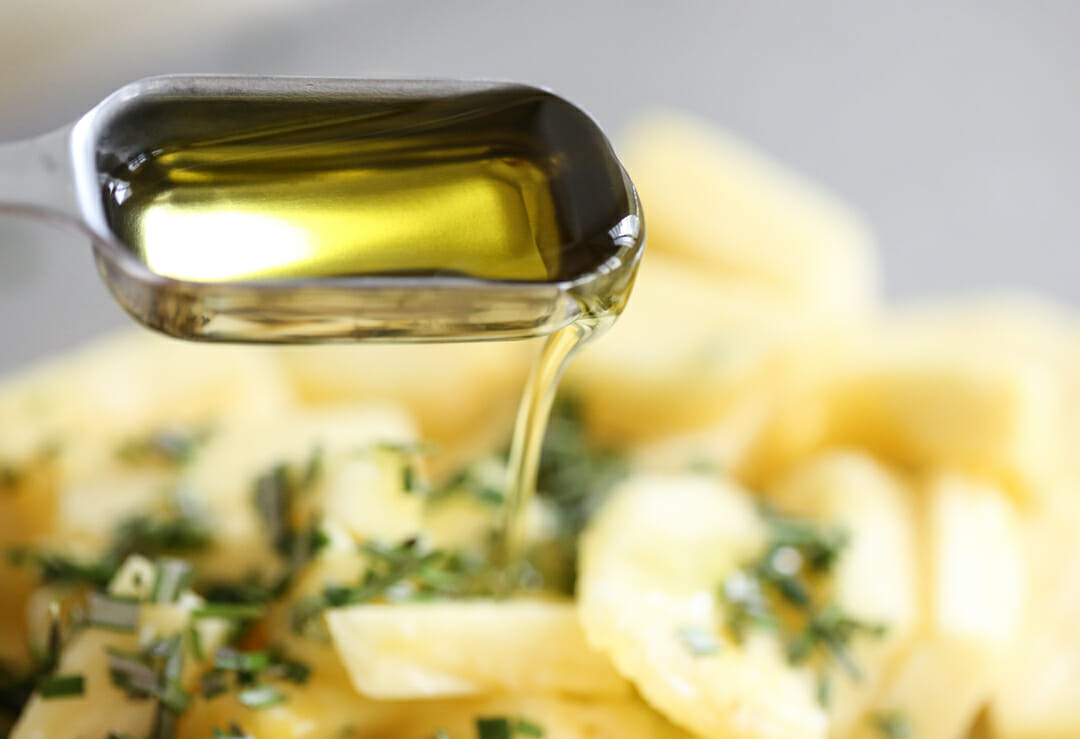 pouring olive oil on pineapple