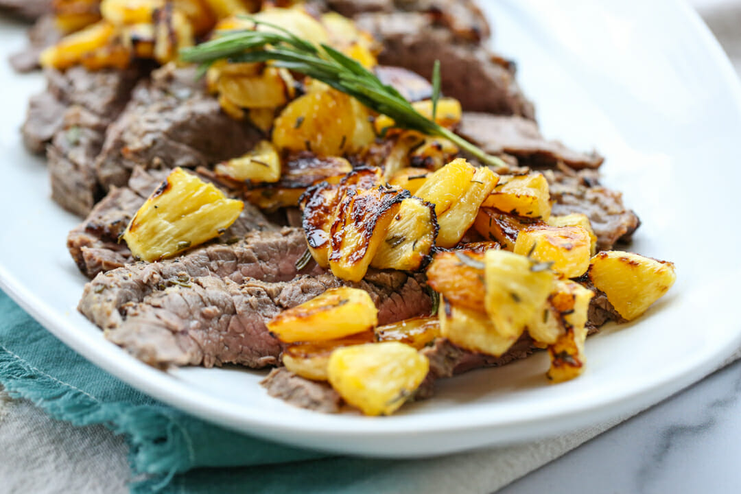 grilled steak with pineapple on top
