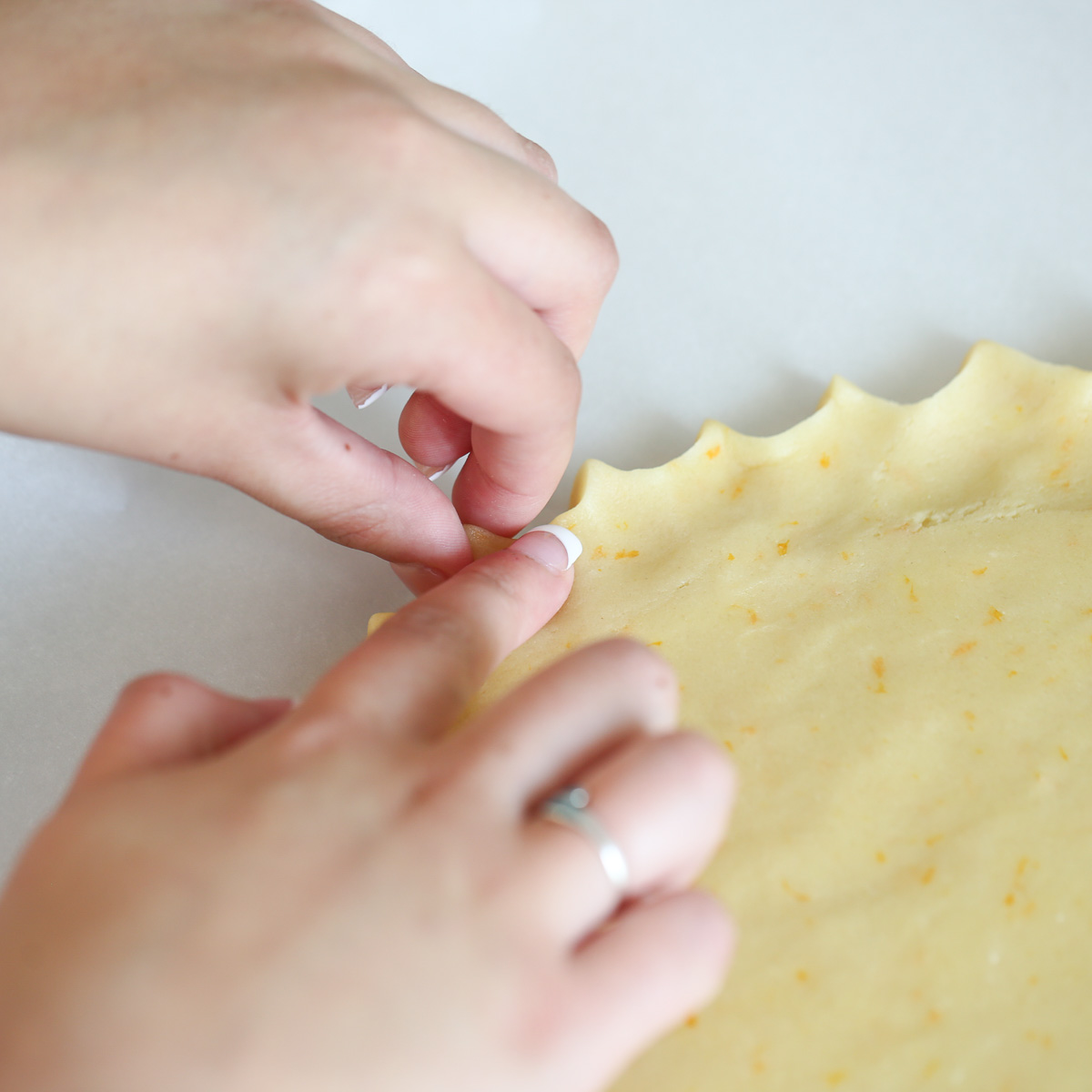 crimping the edge of fruit pizza cookie dough