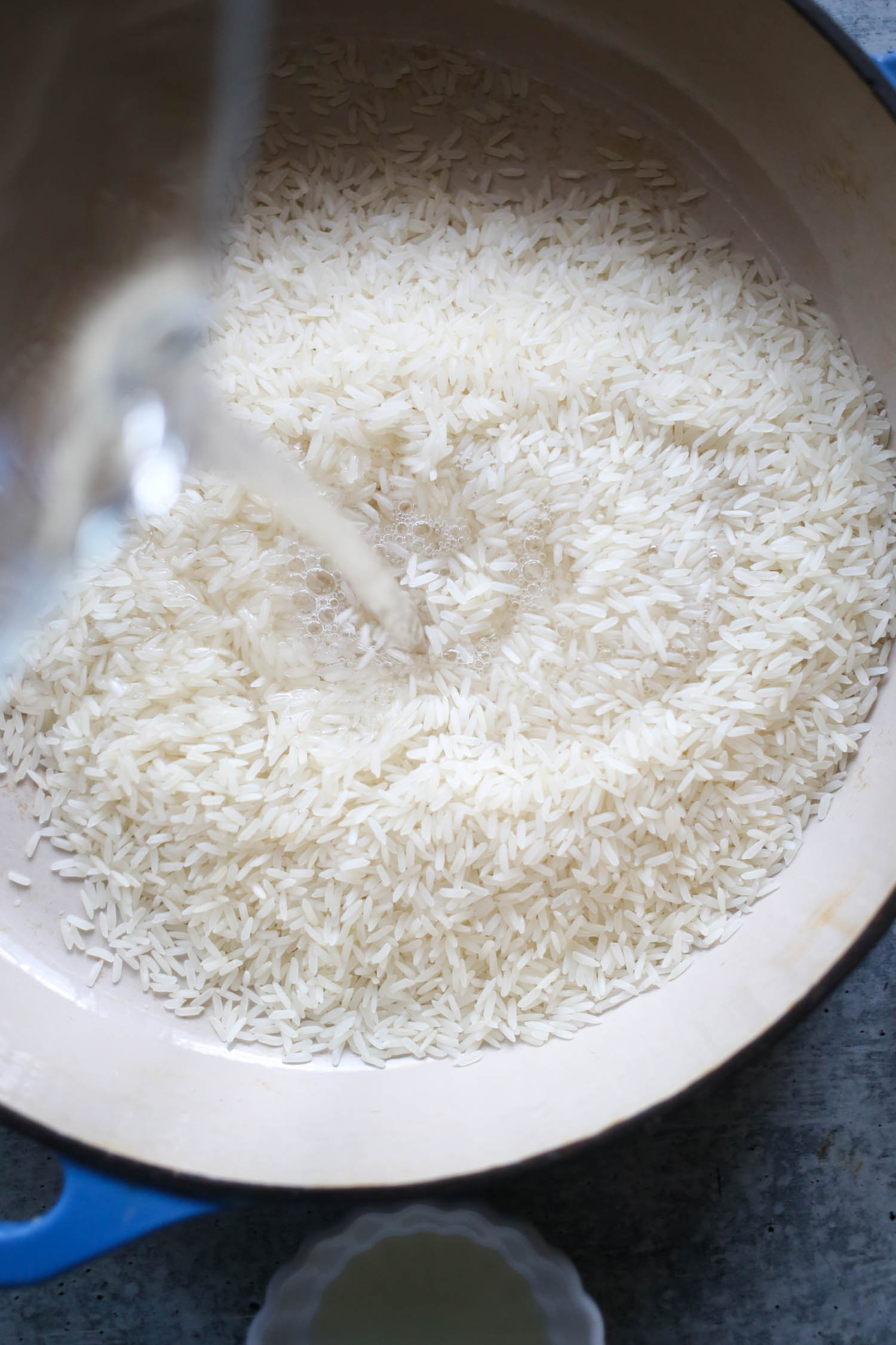 adding water to sweet and savory coconut rice from our best bites