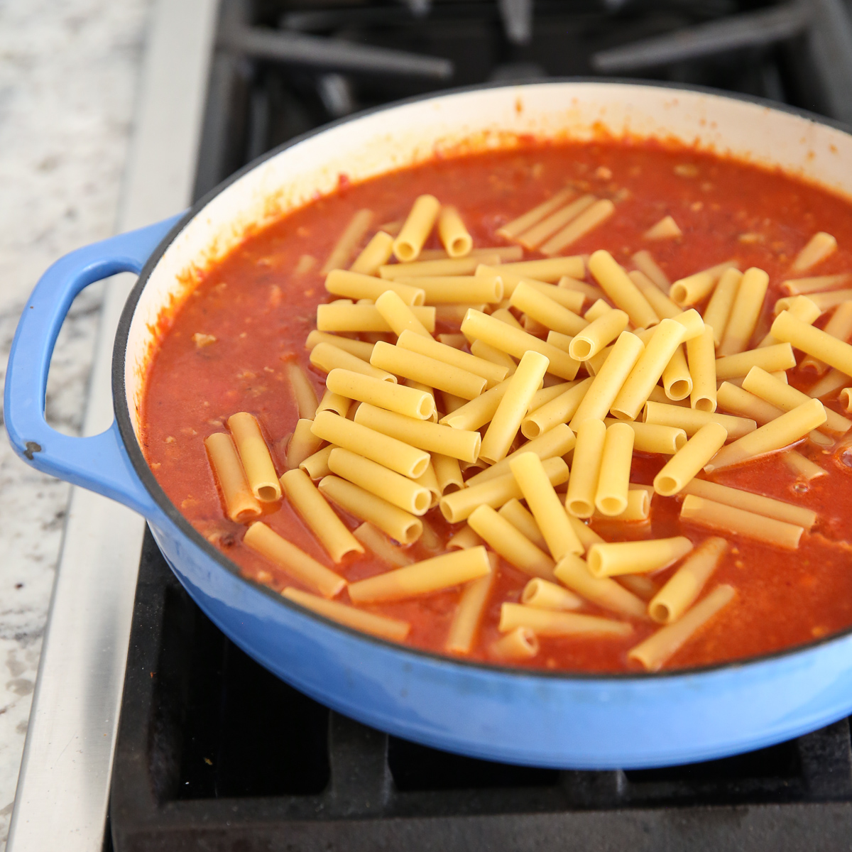noodles in a tomato sauce on the stove top
