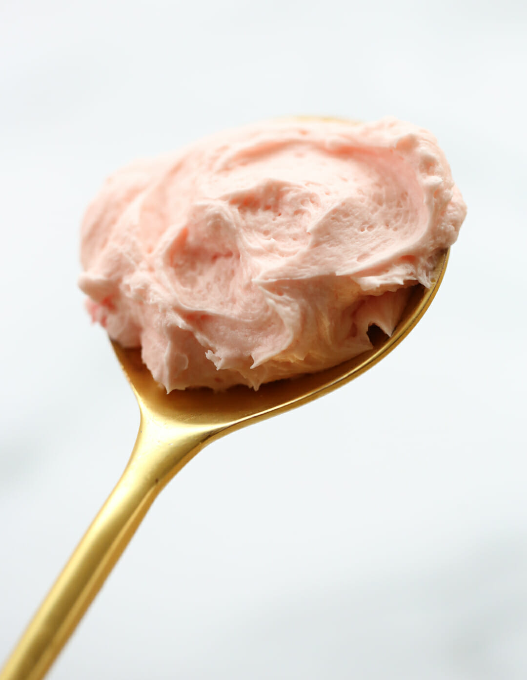 pink buttercream on spoon