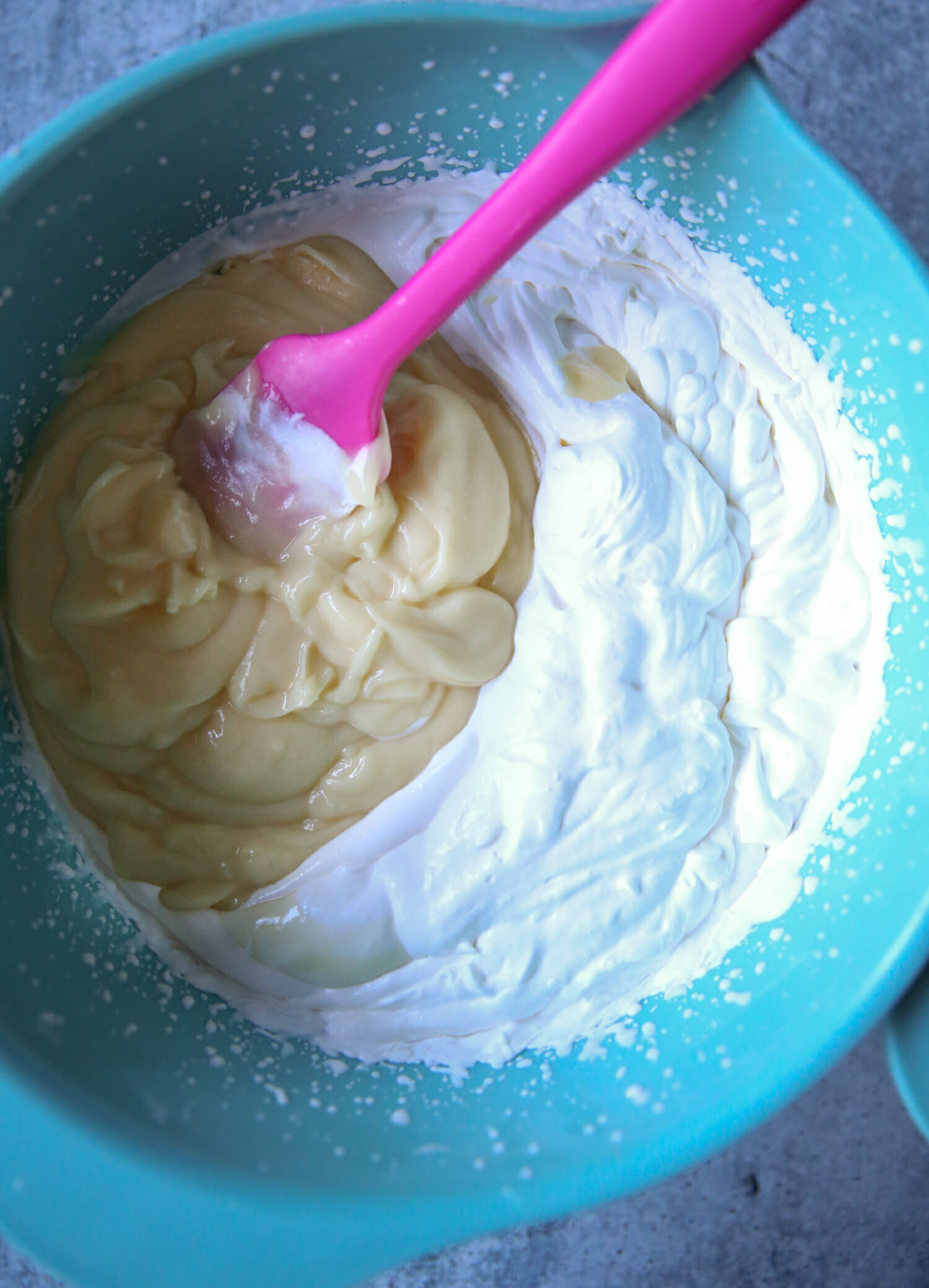 folding the pudding into the cream