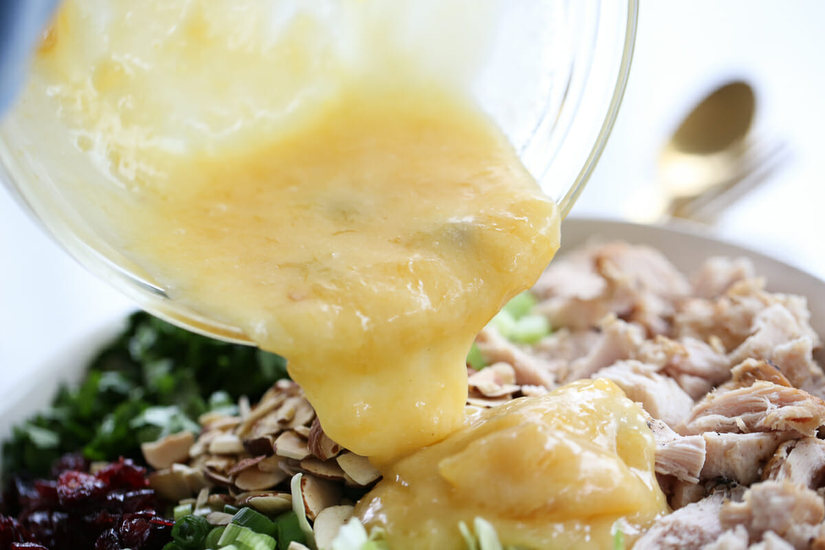 pouring dressing onto salad