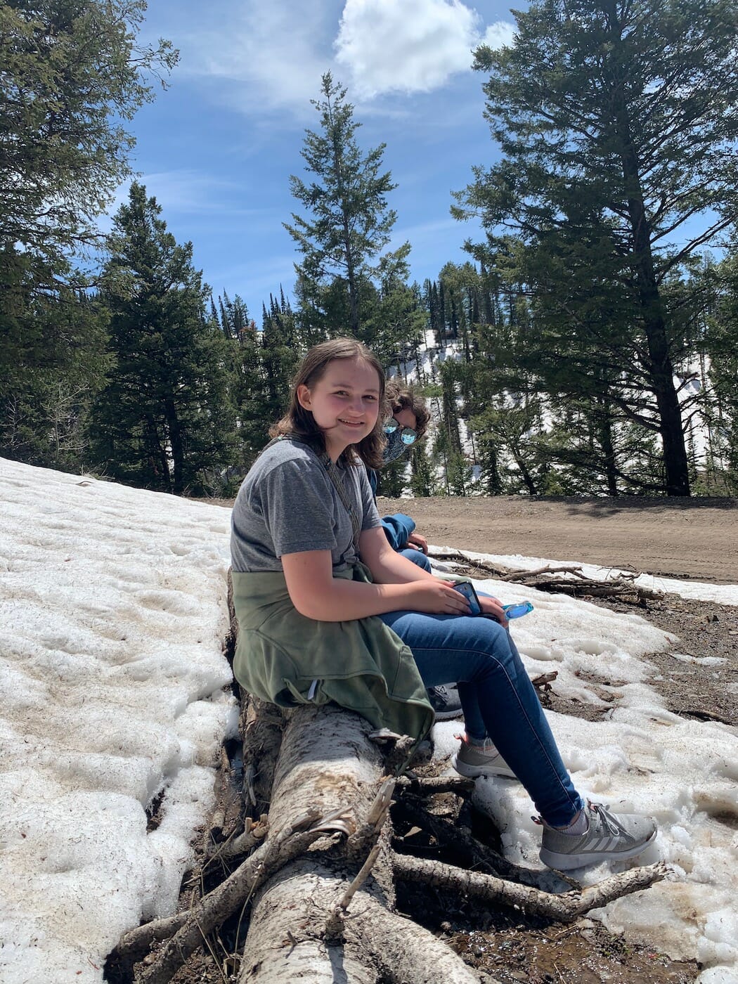 Kids sitting on a log on a hike at Grand Targhee Resort