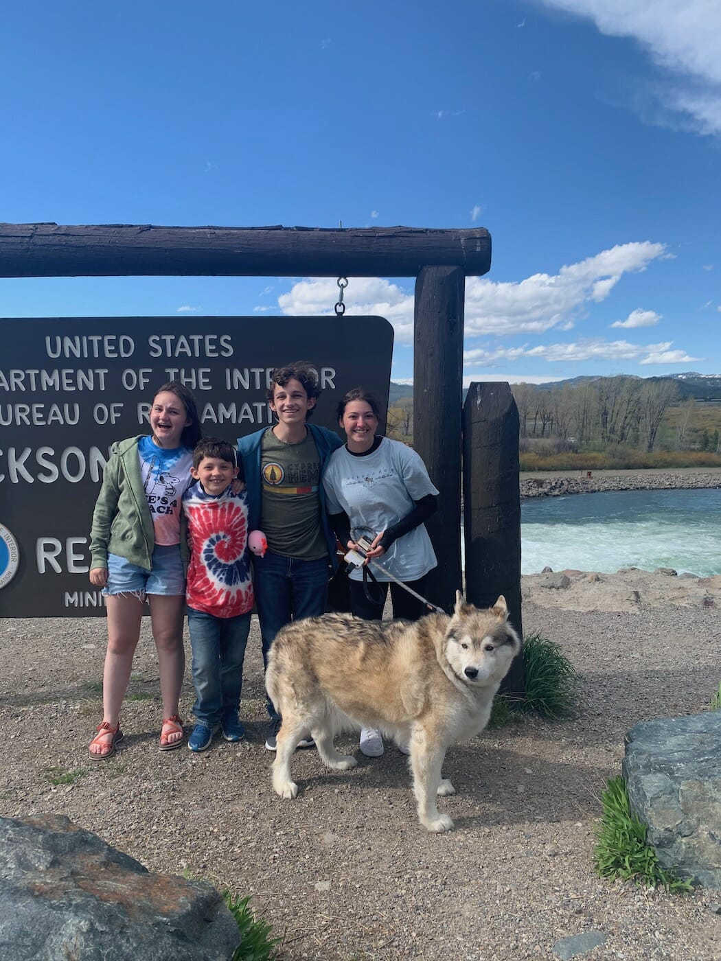 kids in front of Jackson Dam with a dog