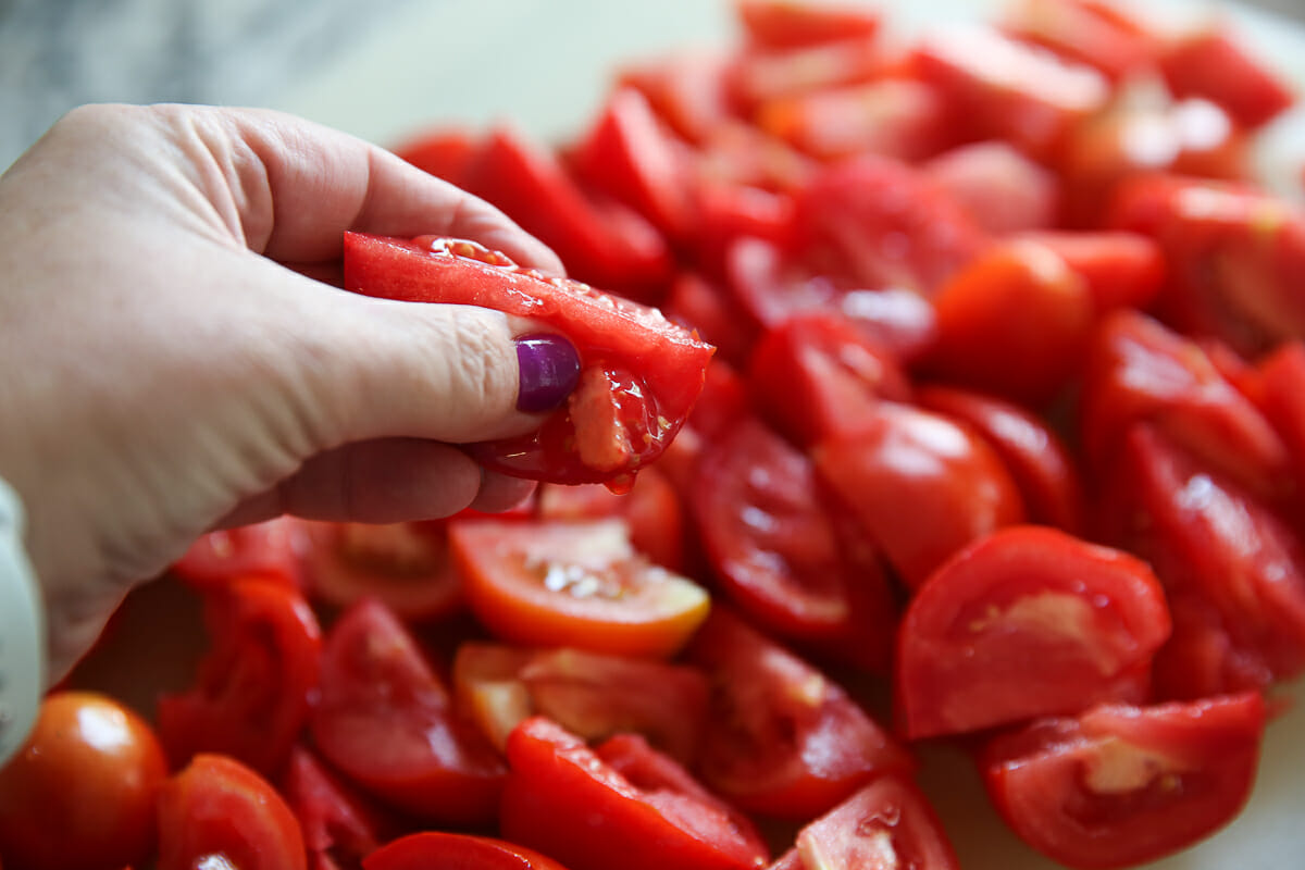 squeezing out pulp from fresh tomato