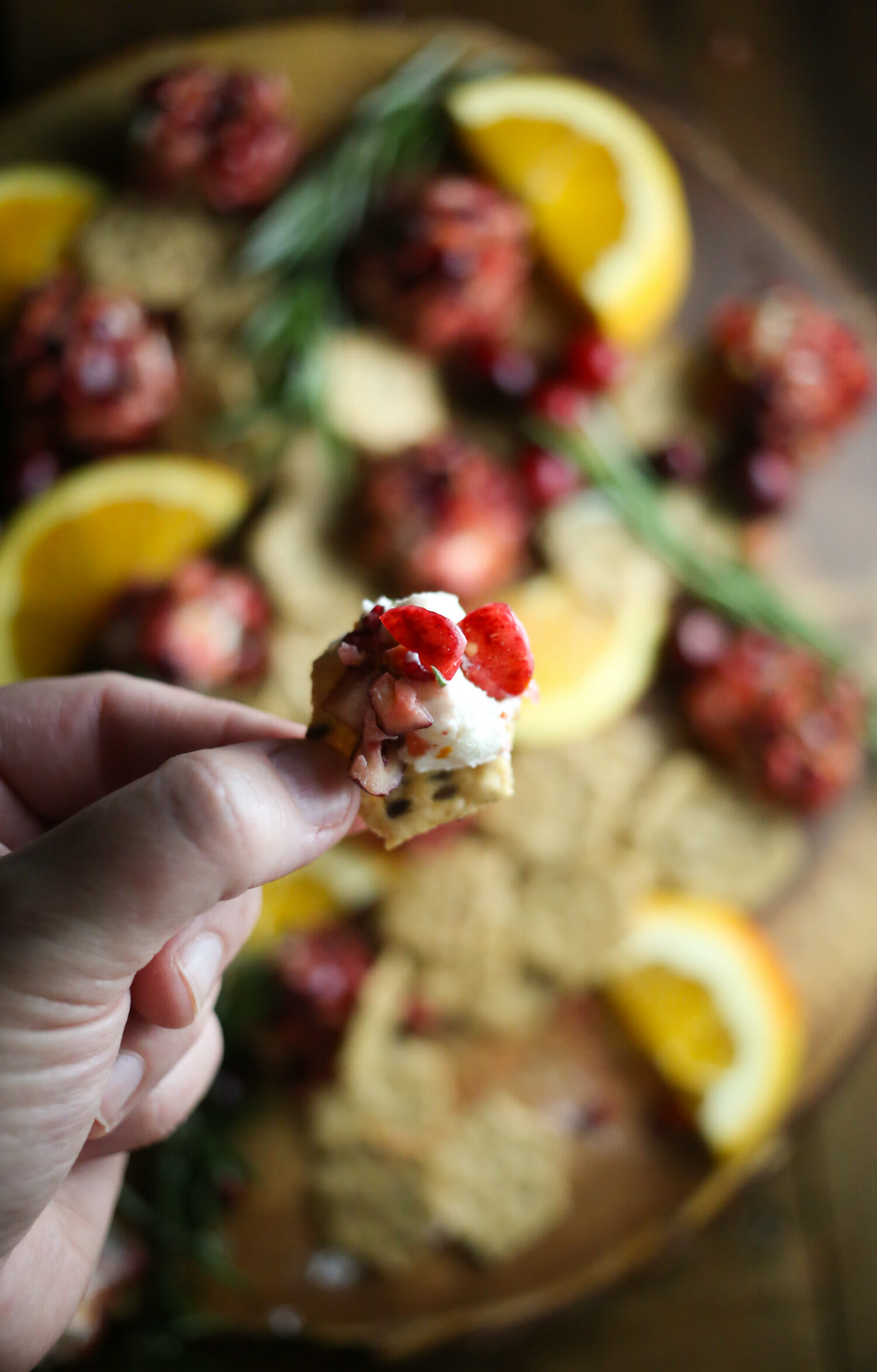 cranberry goat cheese bite on a cracker