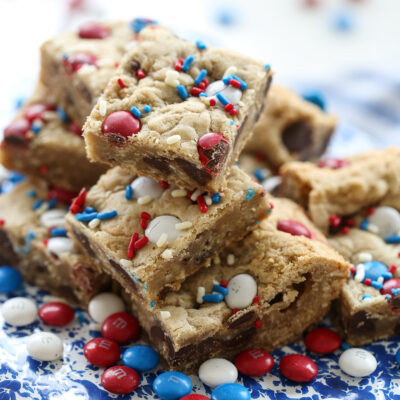 m and m cookie bars on a blue speckled plate