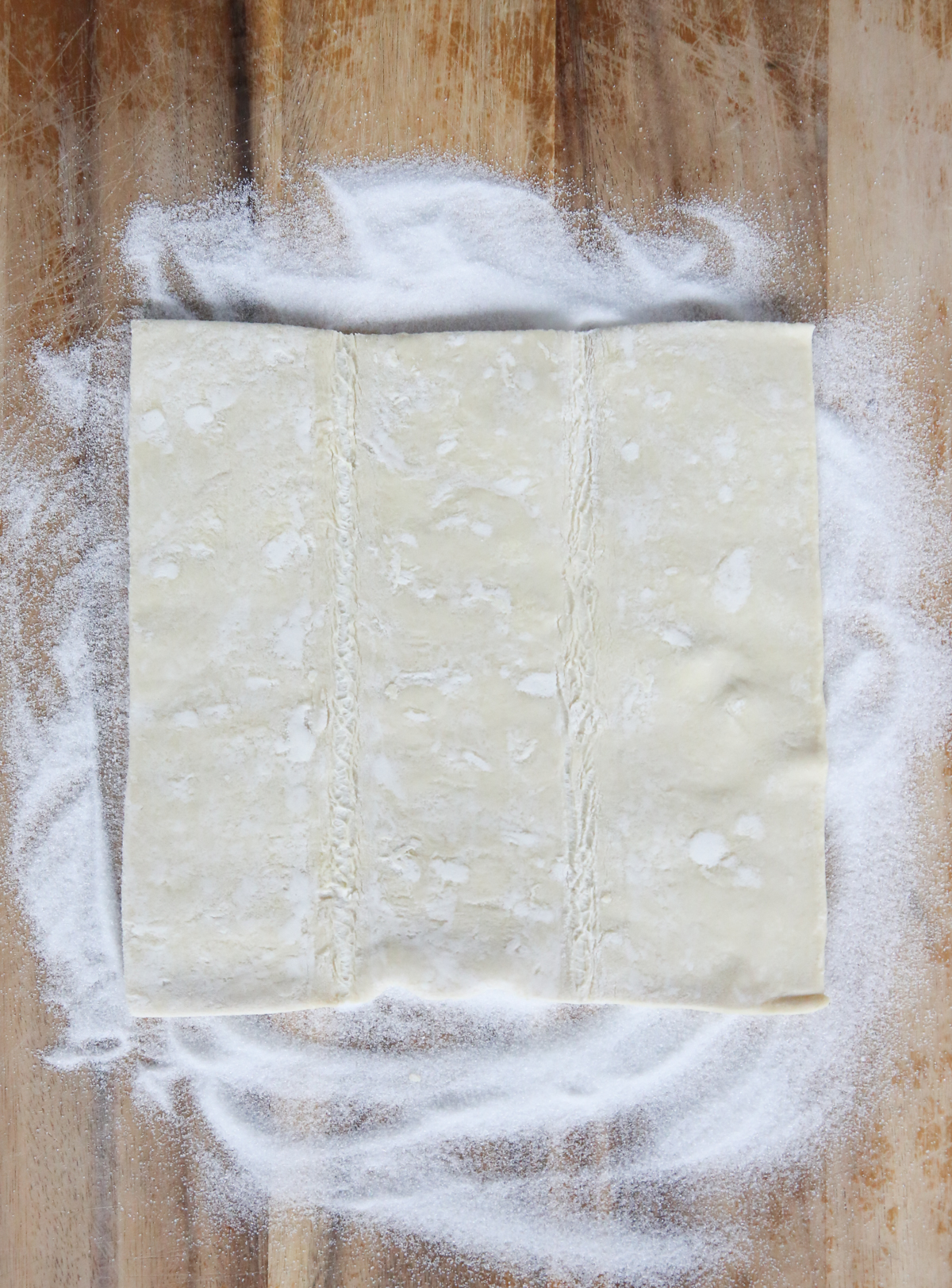 puff pastry on cutting board with sugar