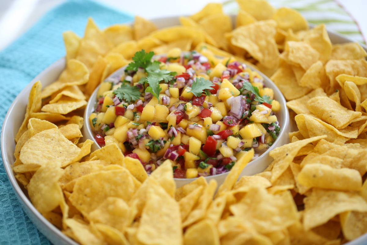 Mango pico de gallo surrounded by tortilla chips