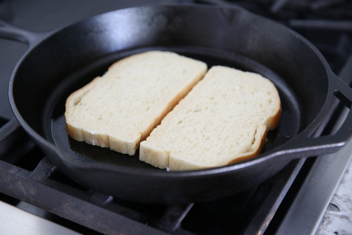 toasting bread in a cast iron pan