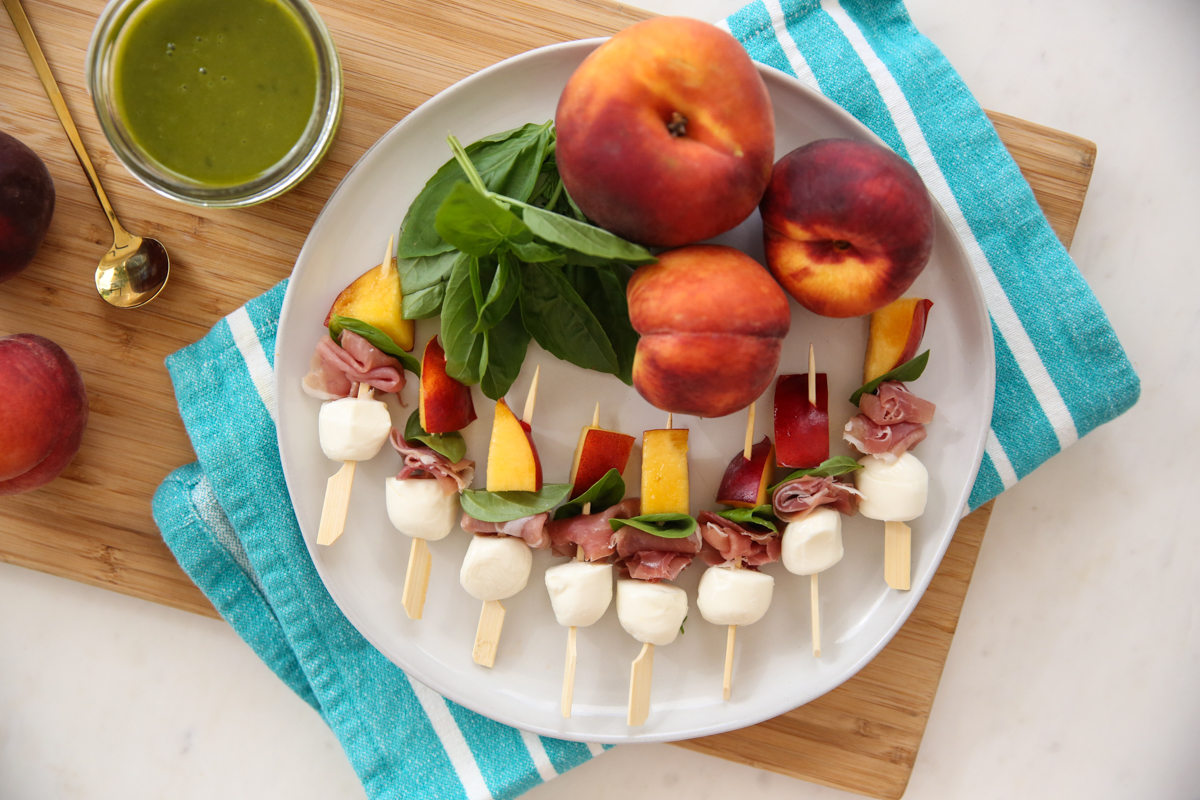 peach mozzarella skewers on a plate