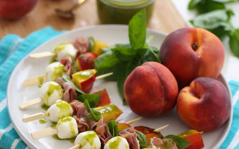 peach mozzarella skewers on a plate
