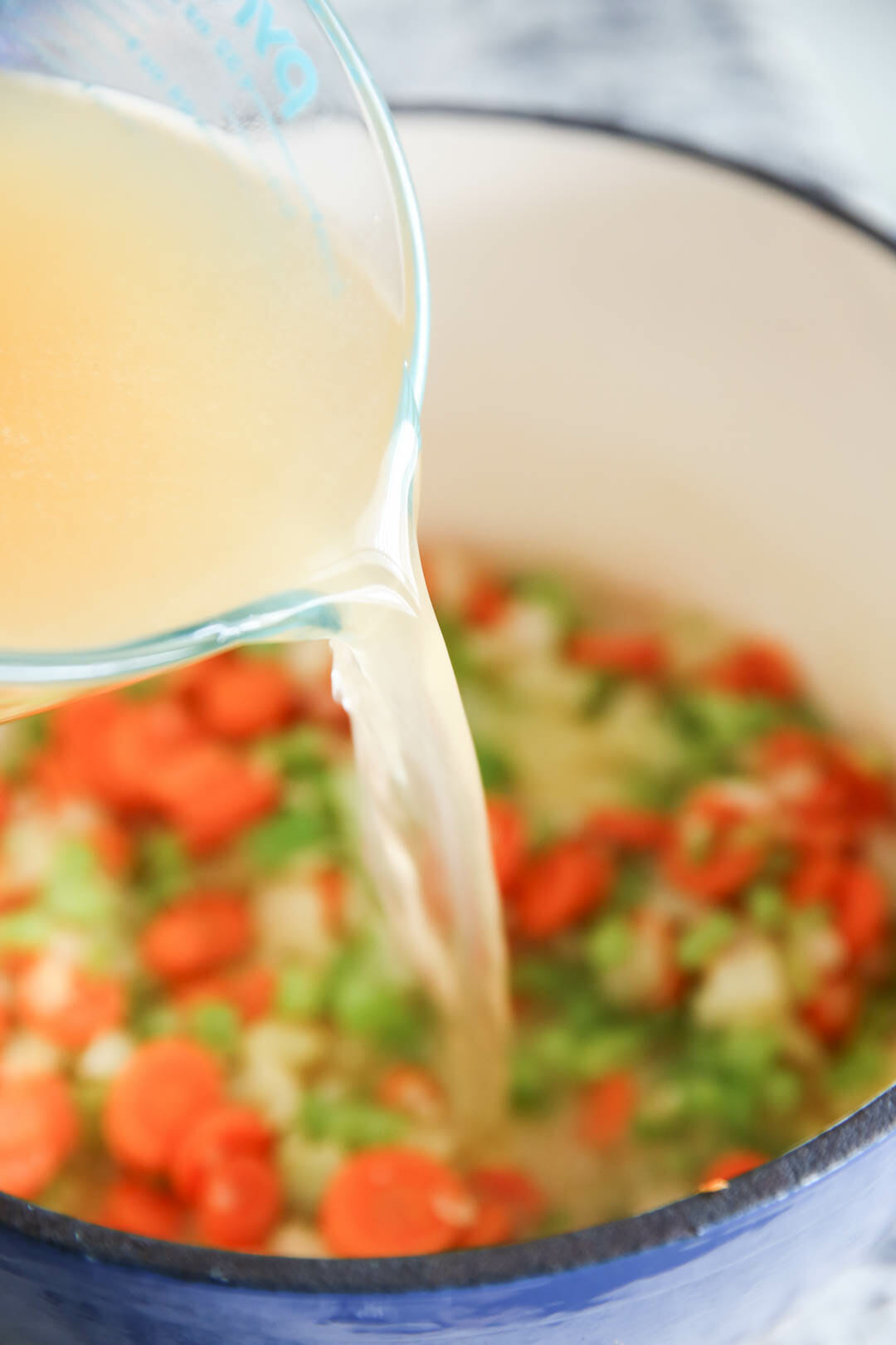 Chicken Broth being poured into soup recipe