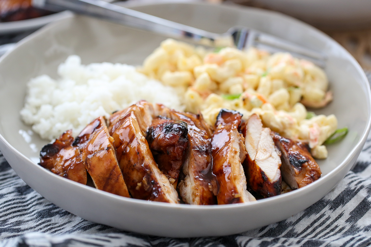 Grilled chicken, white rice, and macaroni salad on a plate. 
