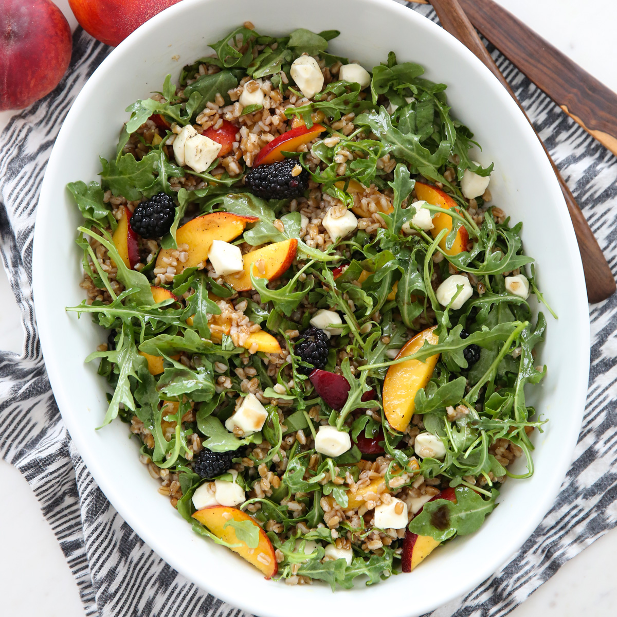 Peach Arugula Salad in a white bowl