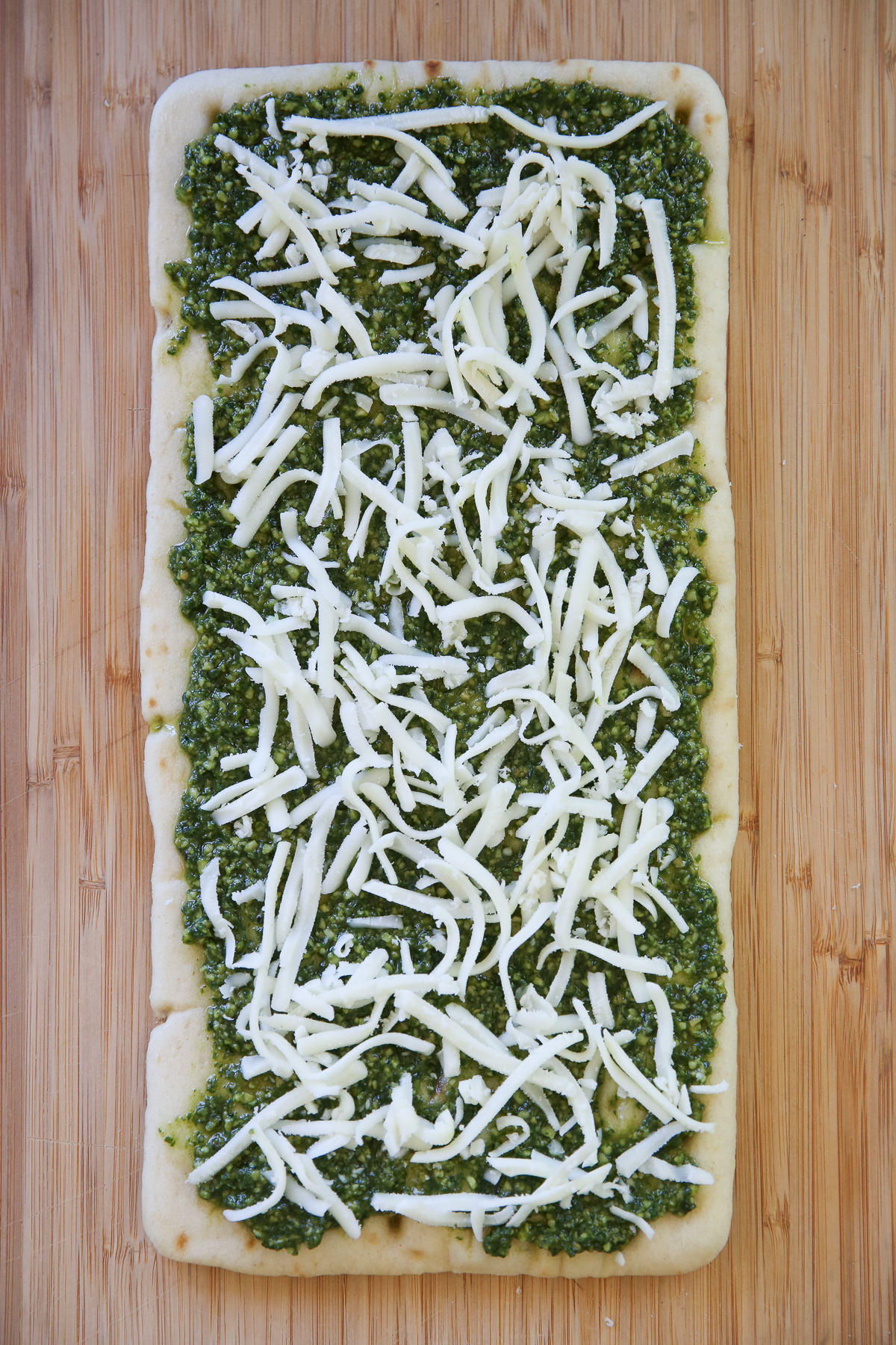 flatbread spread with pesto and cheese