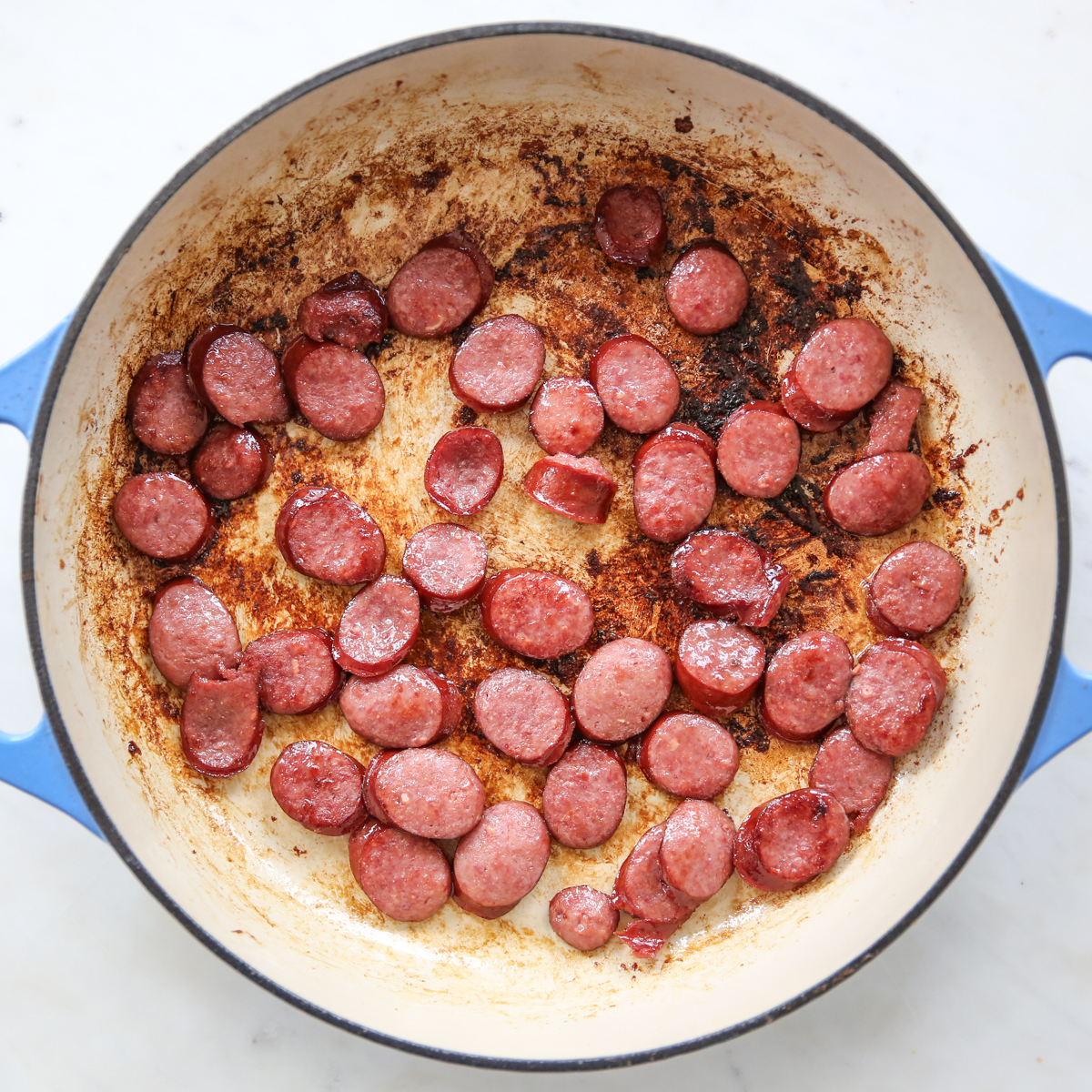browned sliced kielbasa in a skillet