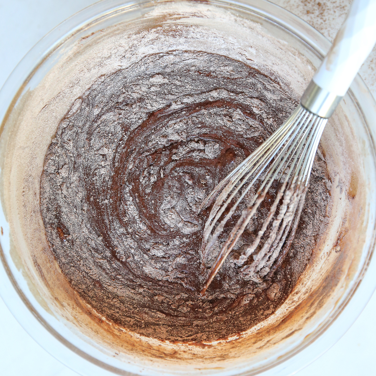 whisking flour into brownie batter