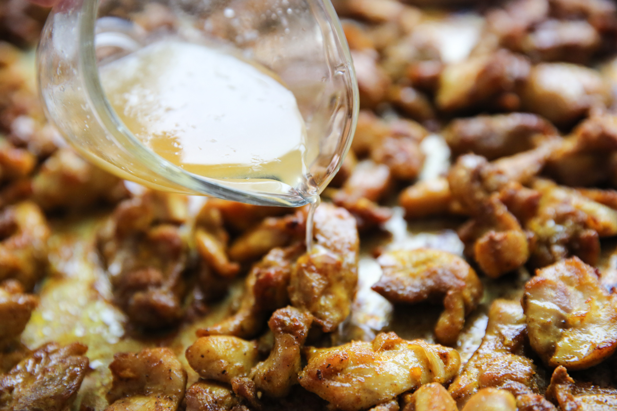 pouring lemon and honey over roasted chicken shawarma