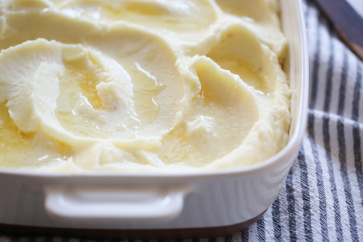 creamy mashed potatoes in a white baking dish