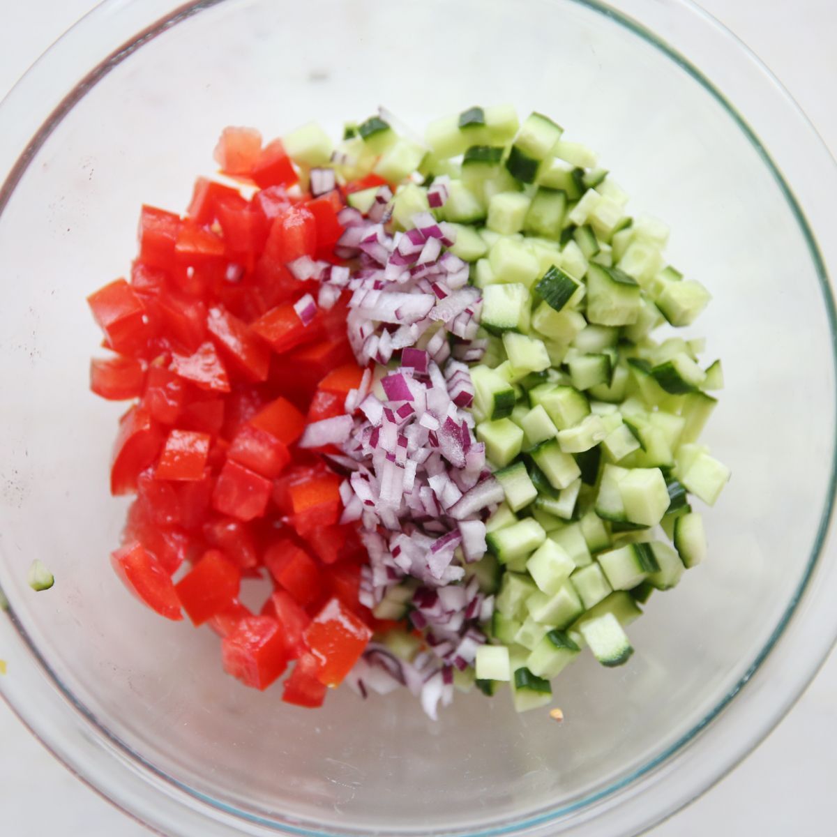 tomato, cucumber and onion in a bowl