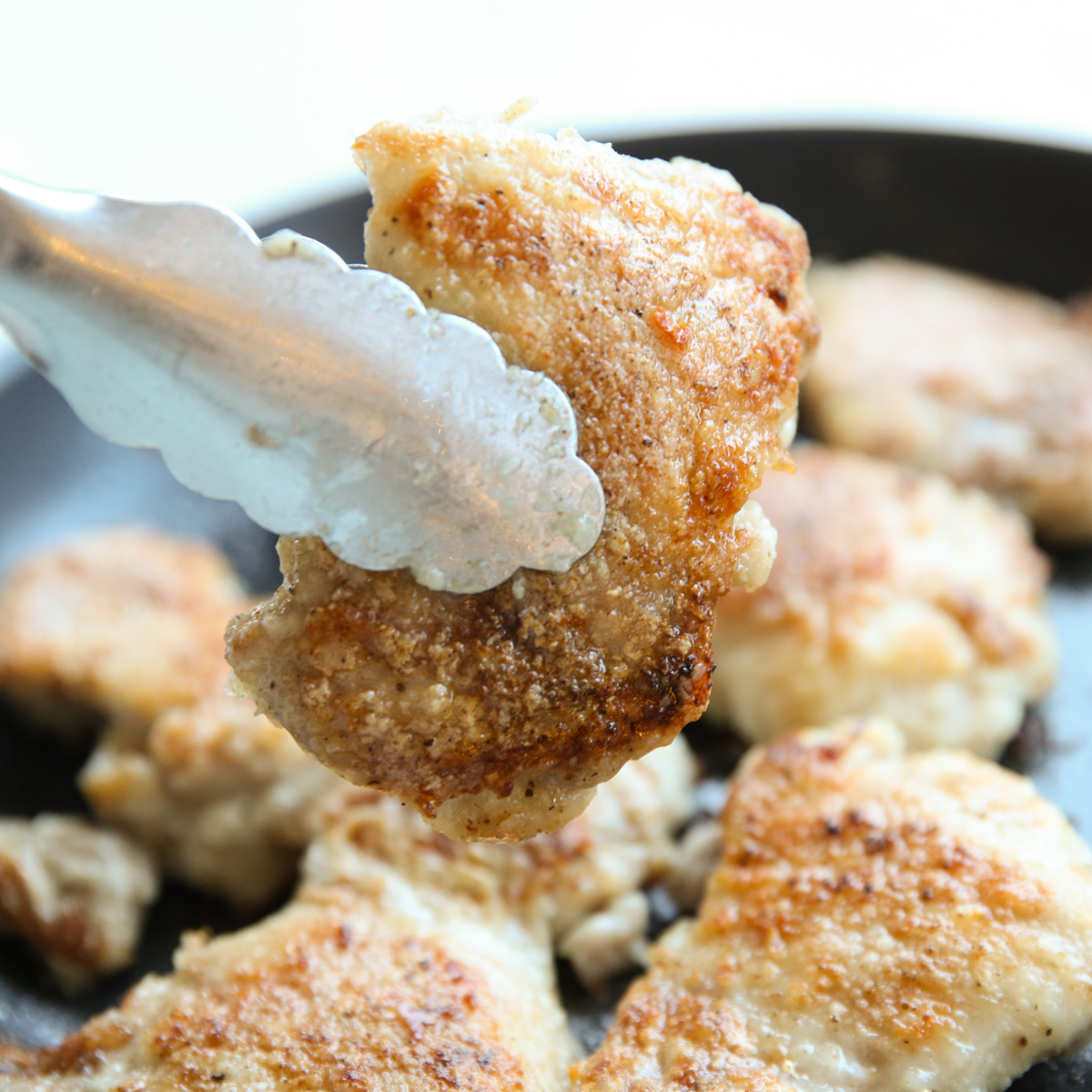 browning chicken thighs in a skillet