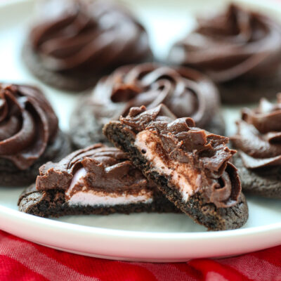 chocolate cookie topped with frosting cut in half with marshmallow center