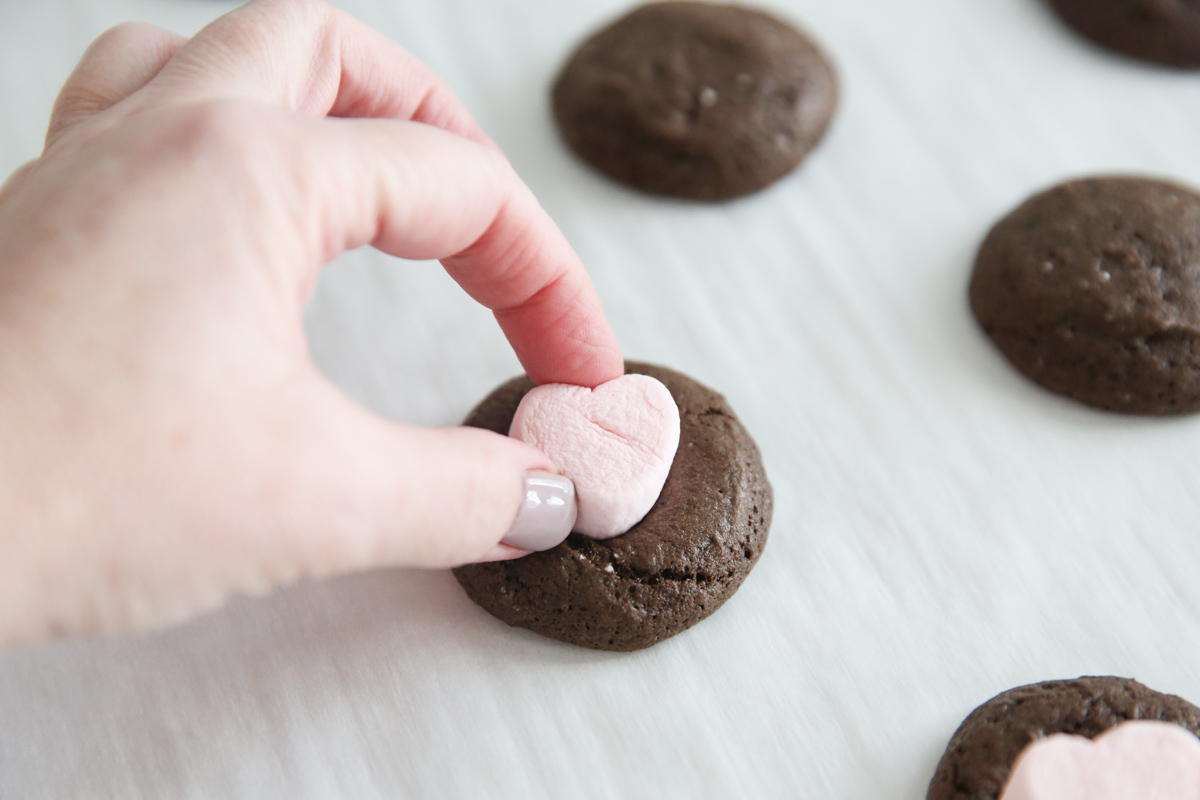 pressing marshmallow into cookie dough