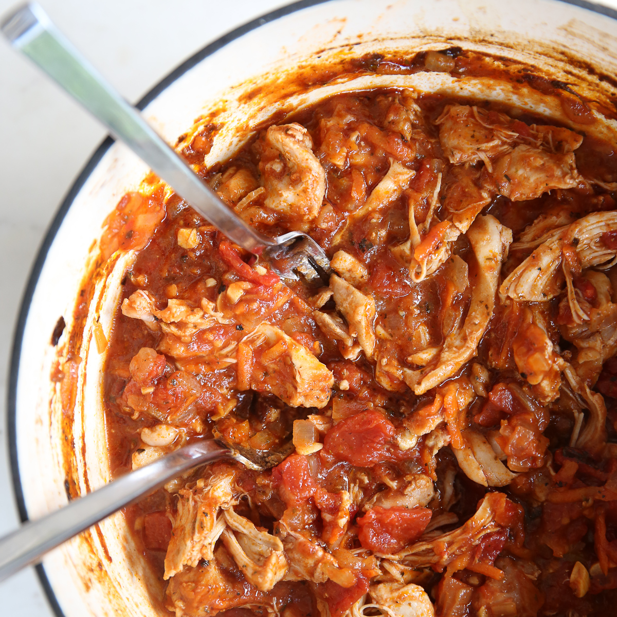 Chicken is shredded in the pot for Braised Italian Chicken.