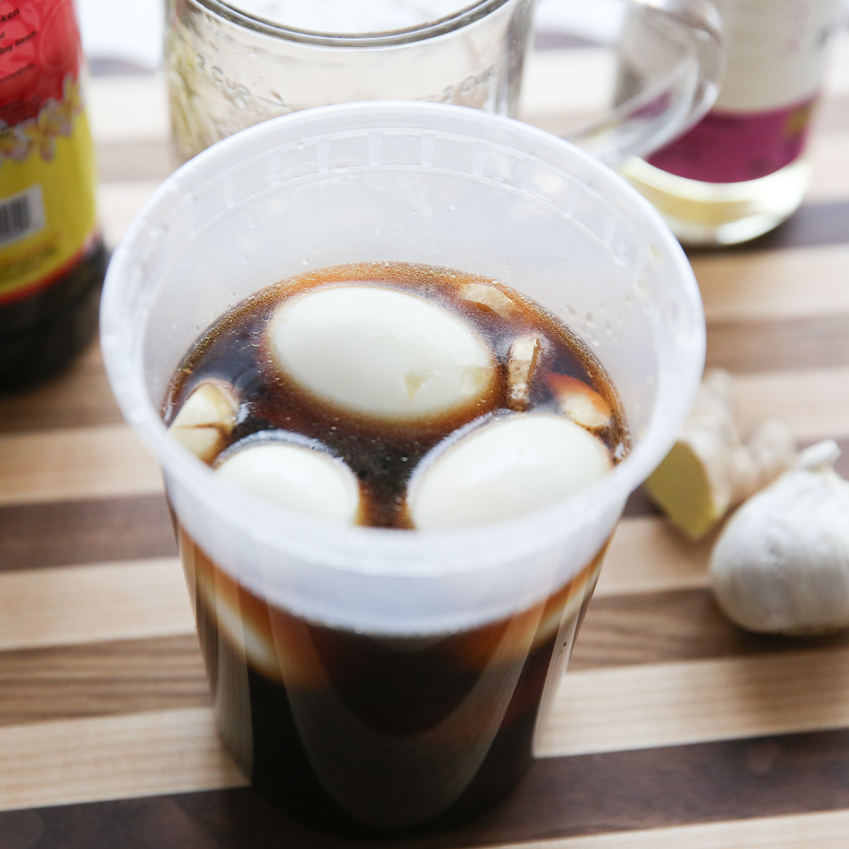 eggs sitting in a deli container with marinade