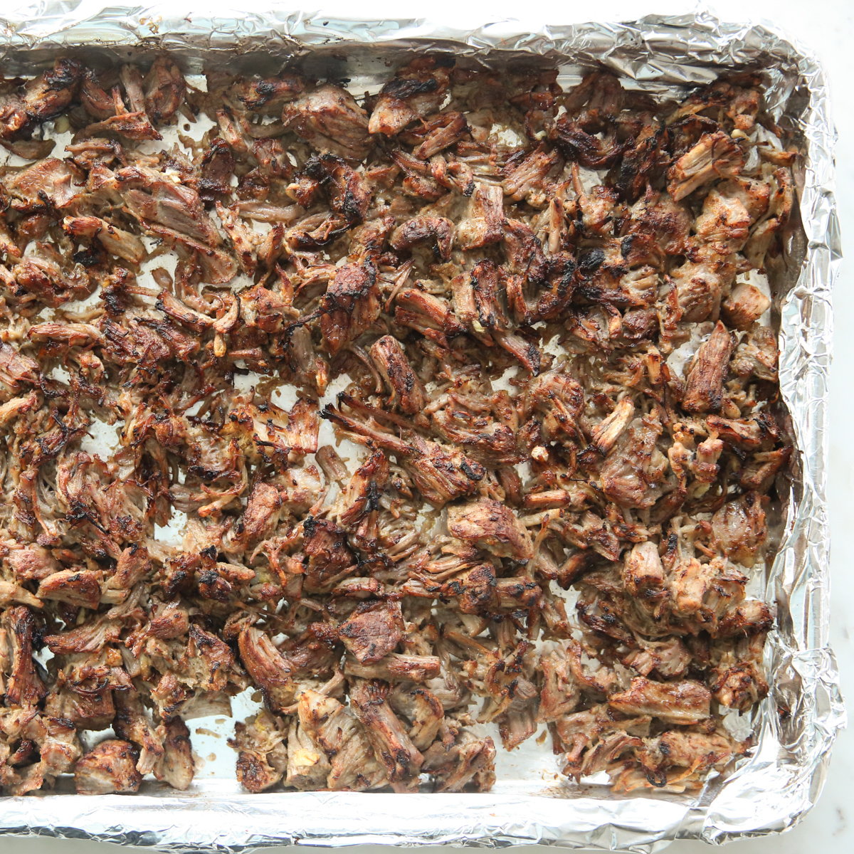 cooked carnitas pork broiled in the oven till crispy
