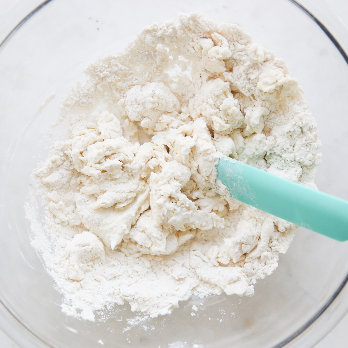 mixing flatbread dough in a bowl