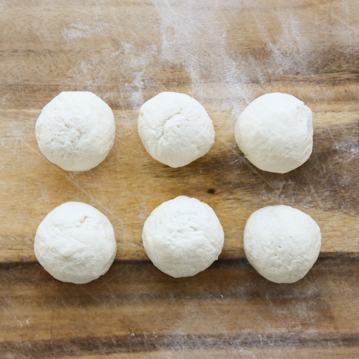 balls of yogurt flatbread dough on a cutting board