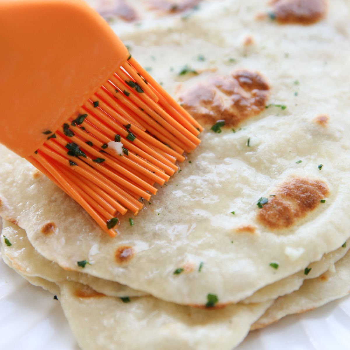brushing flatbreads with butter