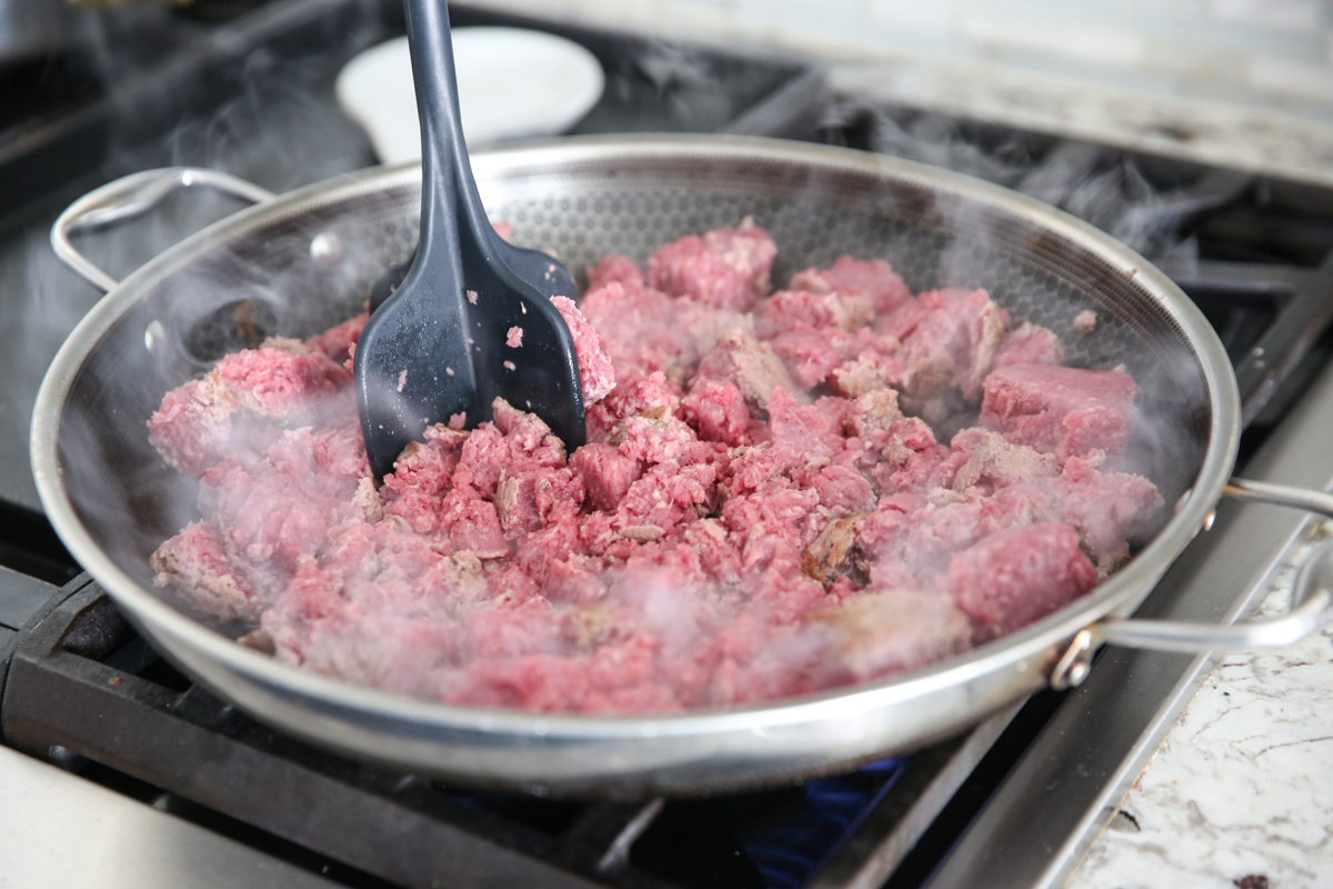 ground beef being cooked in a pan
