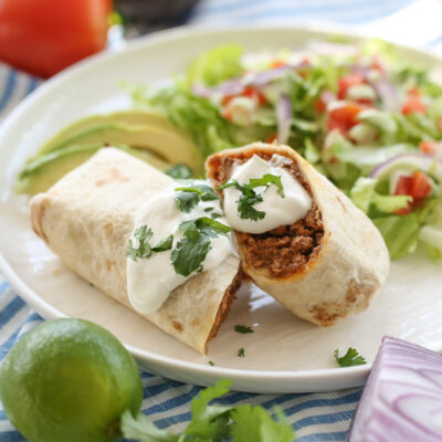 burrito sliced in half on a white plate