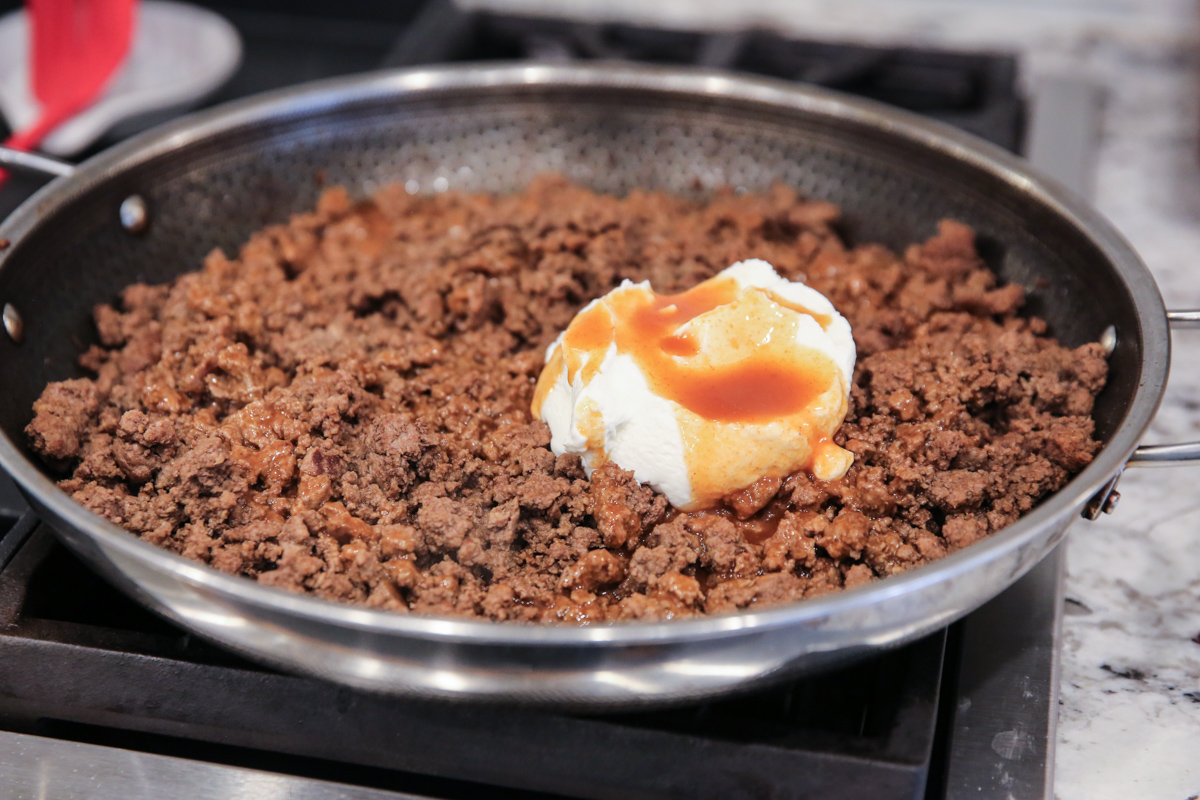 greek yogurt and enchilada sauce on ground beef