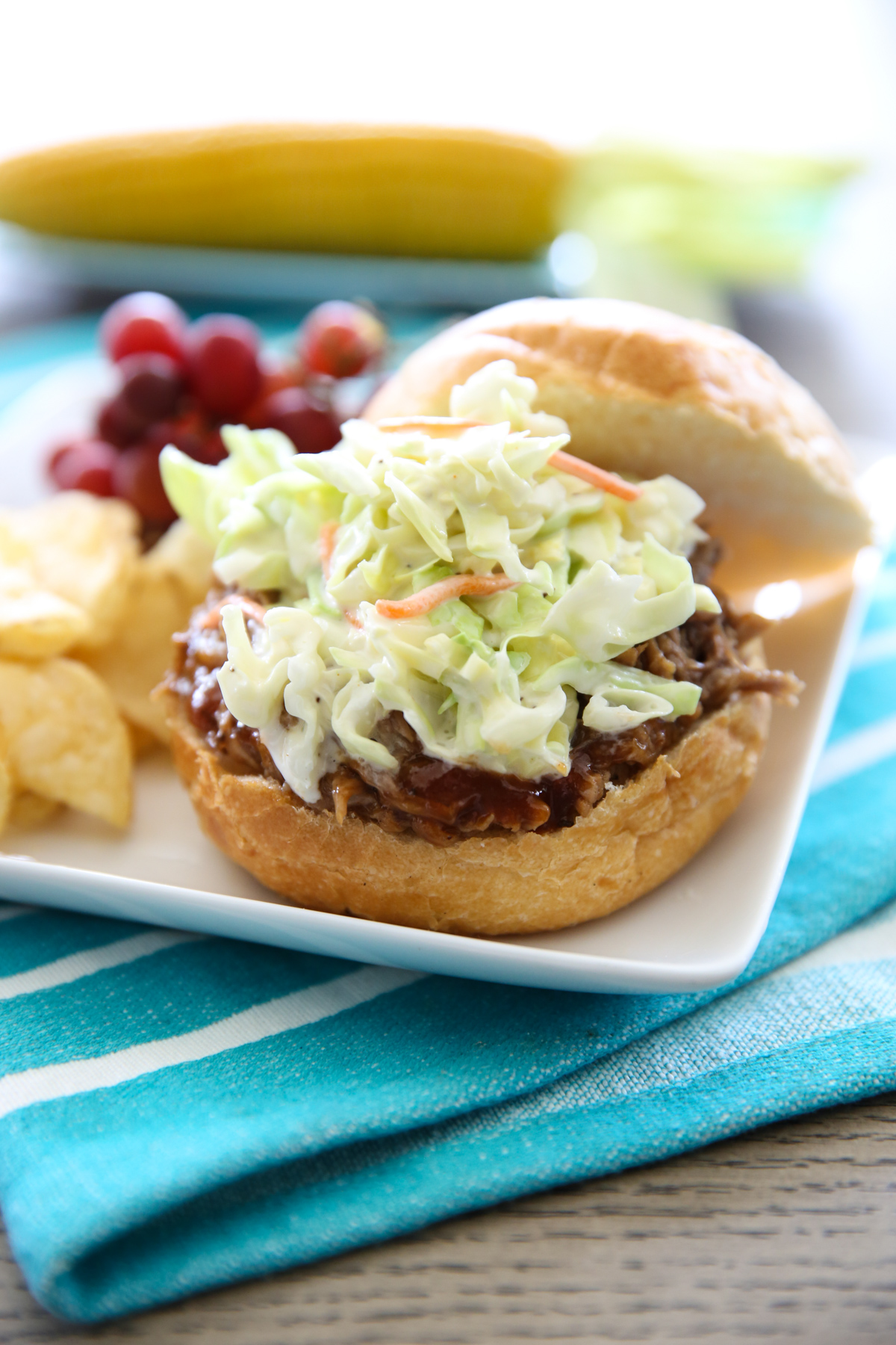 bbq pulled pork on a bun with coleslaw on top