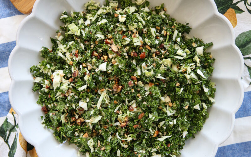 Kale crunch salad in a white bowl on a serving table