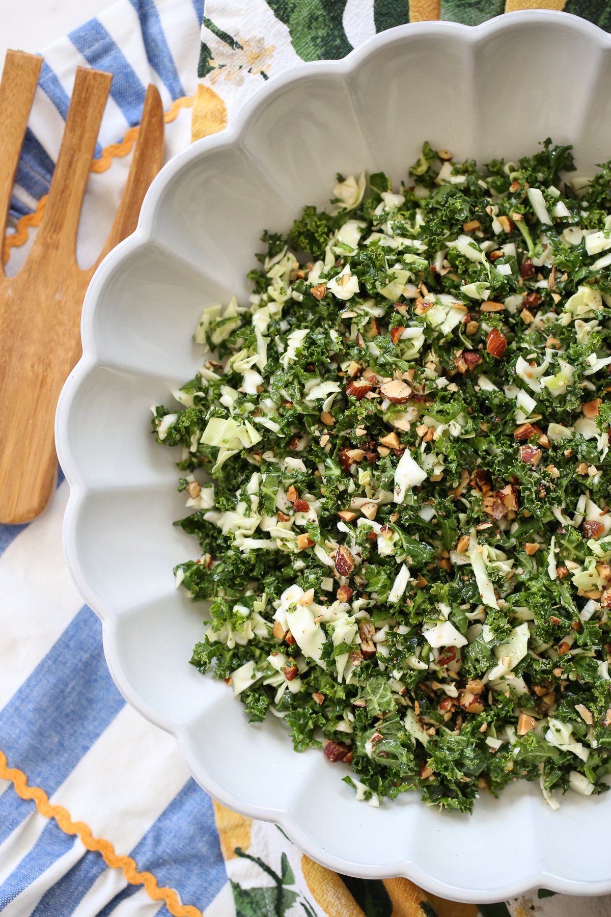 Kale crunch salad in a white bowl on a serving table